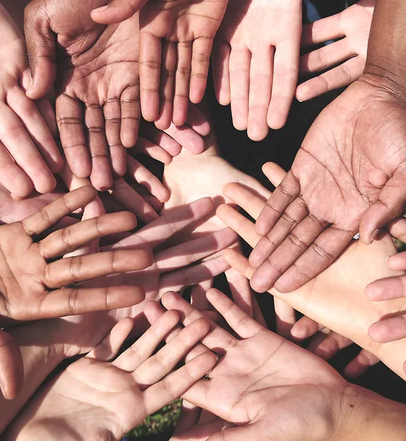 TREC Homepage Community Outreach - diverse hands with palms facing up with one hand having a mole on the wrist