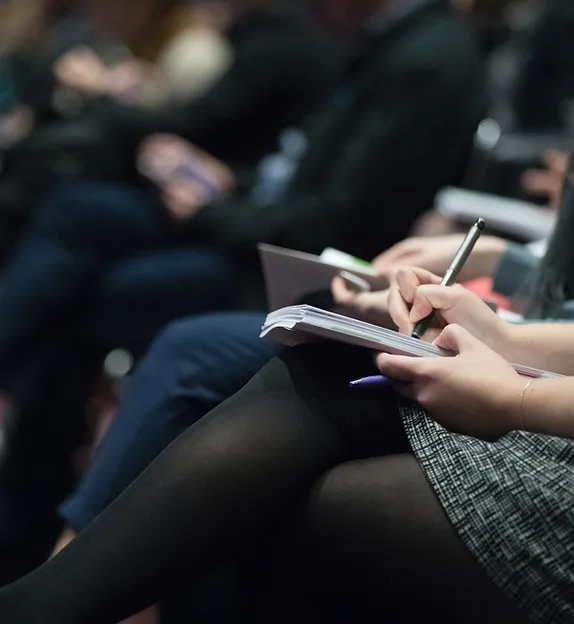 TREC DC Education & Workshops - depicting people taking notes on note books at conference or workshop